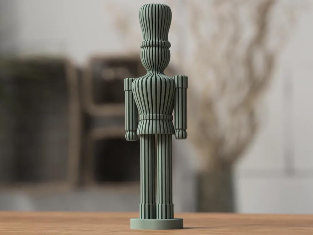 Green decorative statue on a wooden surface with a blurred background