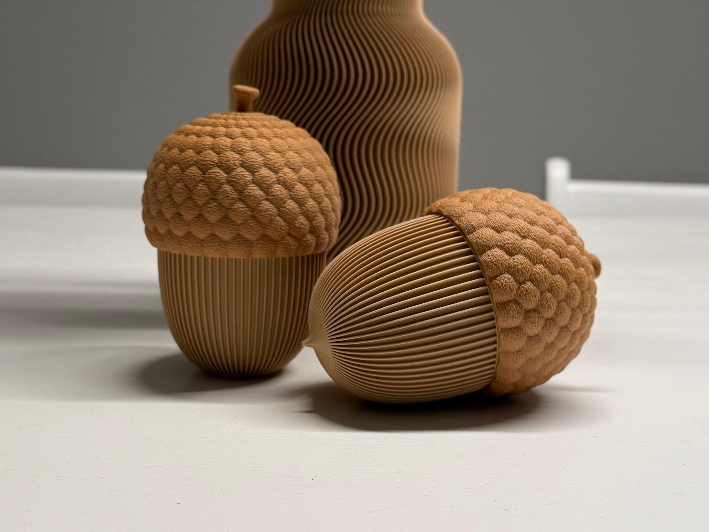Three brown textured acorn-shaped objects on a light gray background