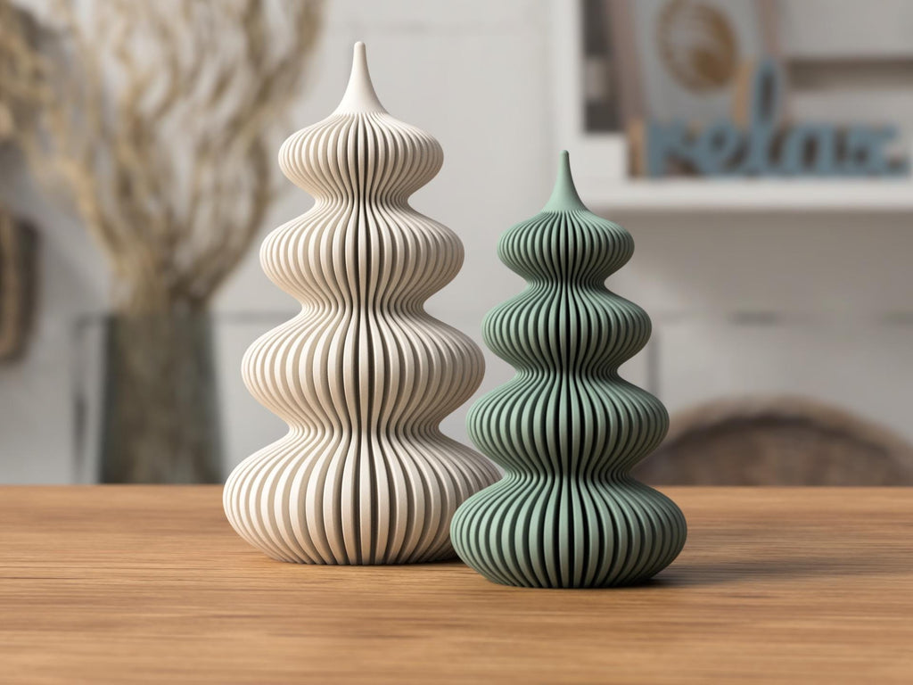 Two decorative towers, one beige and one green, on a wooden surface with a blurred indoor background.