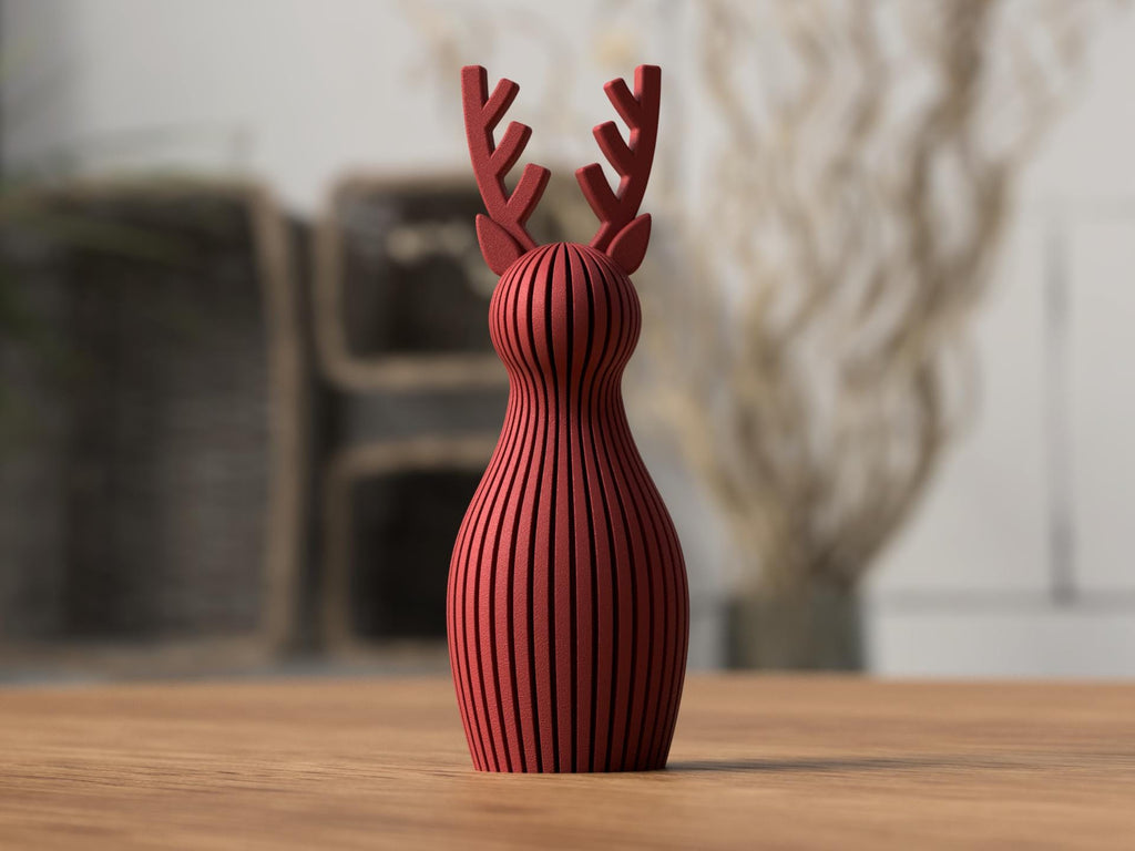 Red deer-shaped vase on a wooden surface with a blurred background