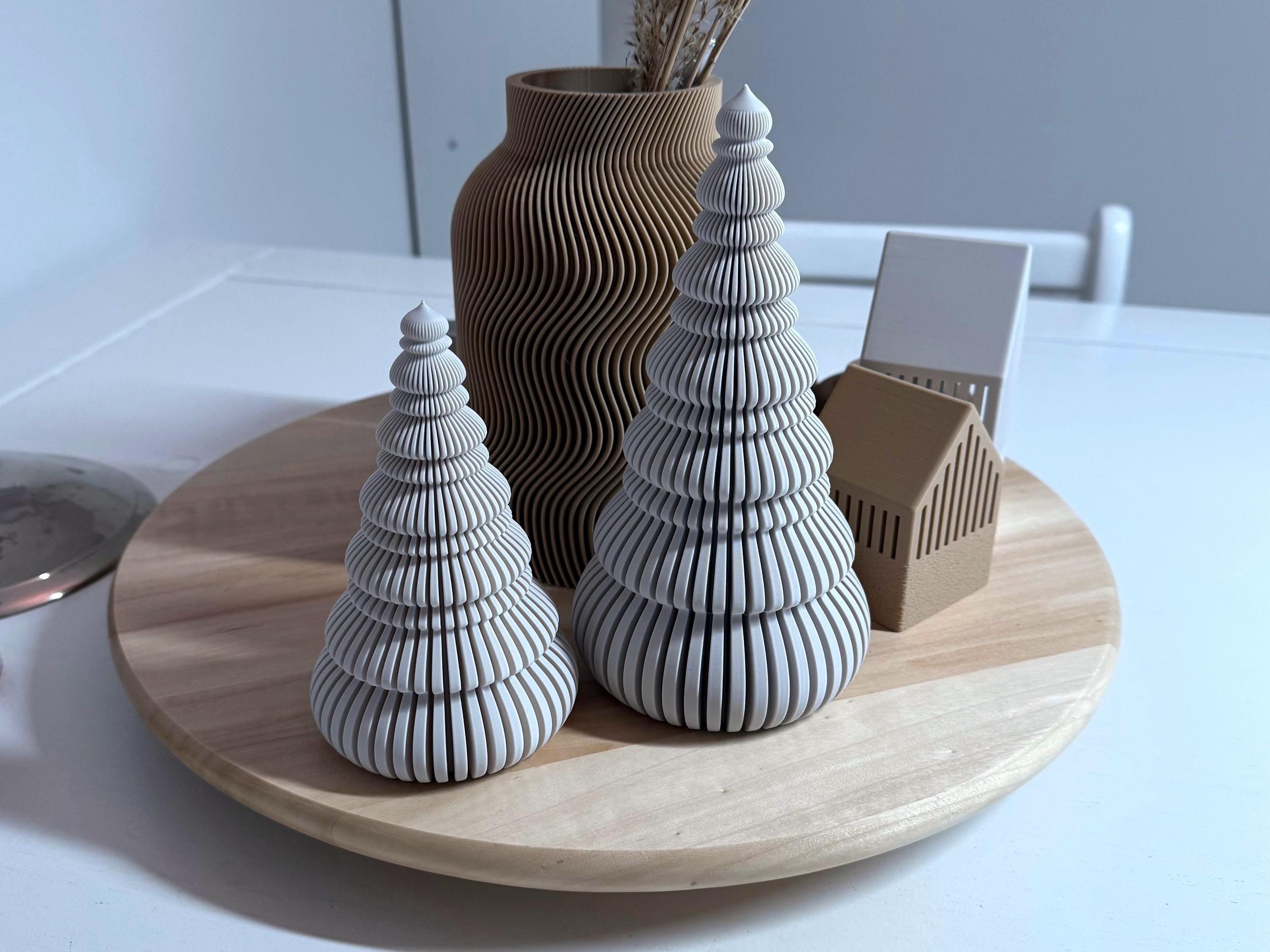 Decorative ceramic pieces on a wooden plate with a plain background