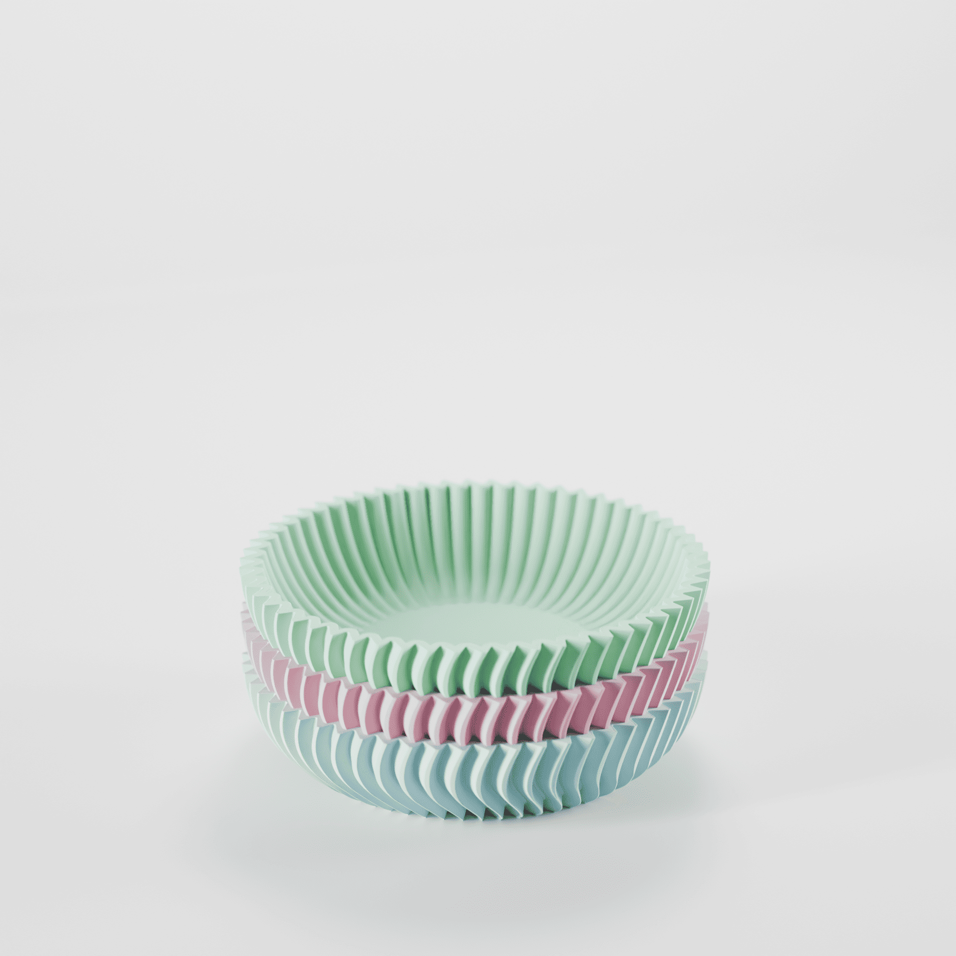 Stack of green and pink ribbed bowls on a white background