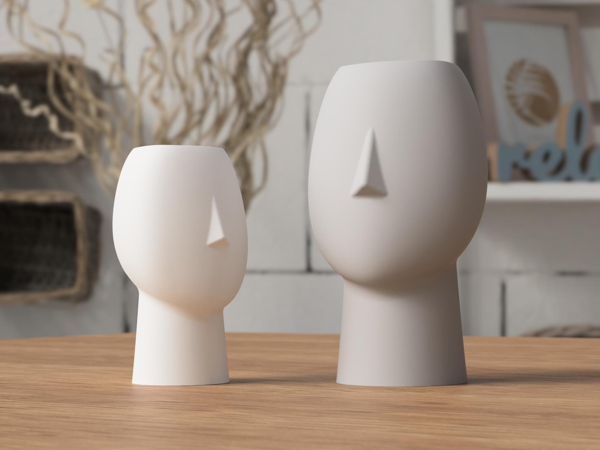 Two white ceramic face-shaped vases on a wooden surface with a blurred indoor background.