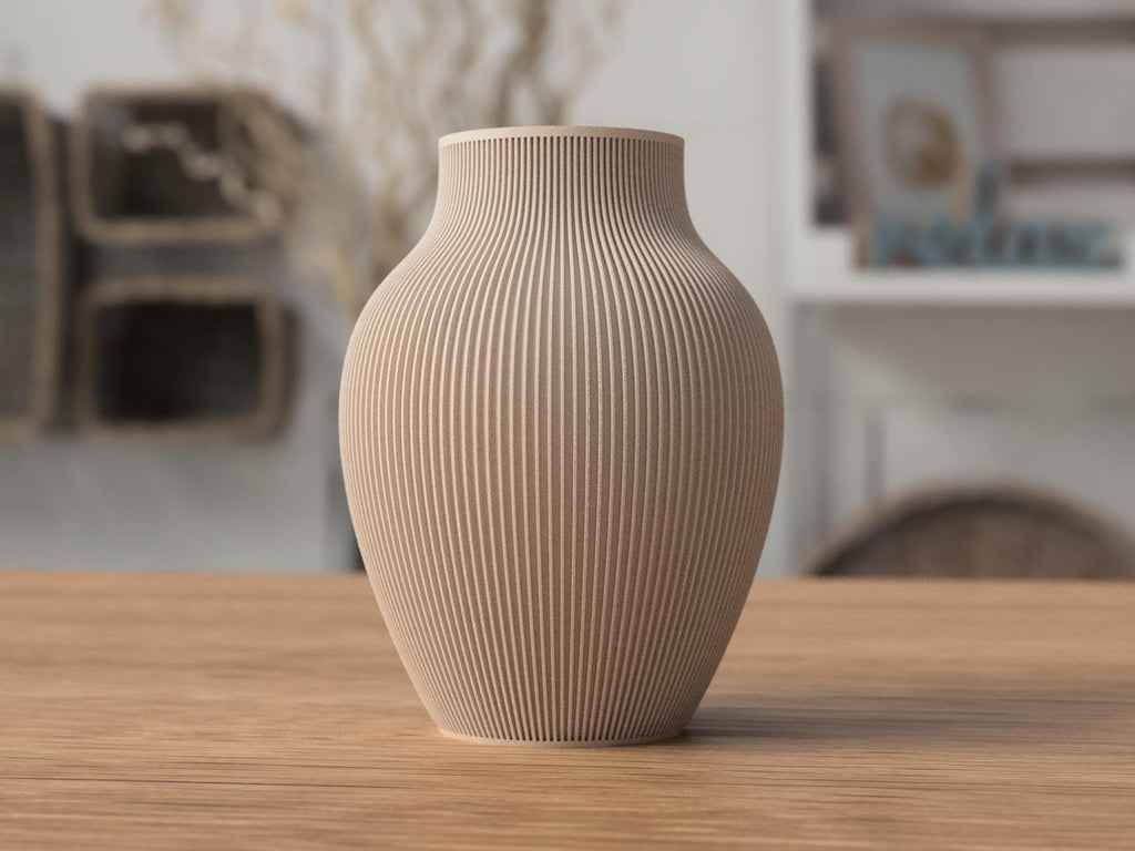 Beige textured vase on a wooden table with a blurred indoor background
