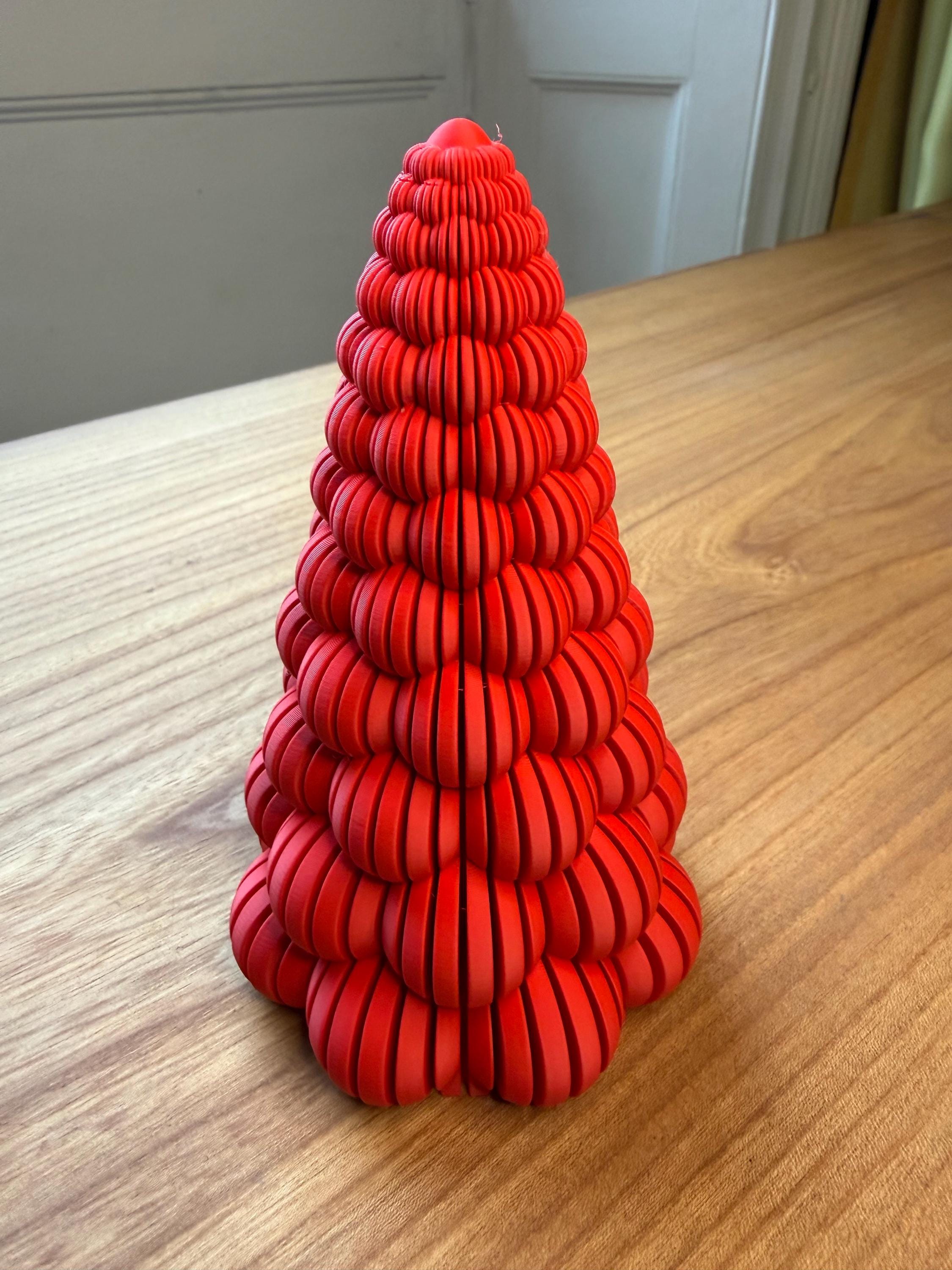 Red spiral sculpture on a wooden surface