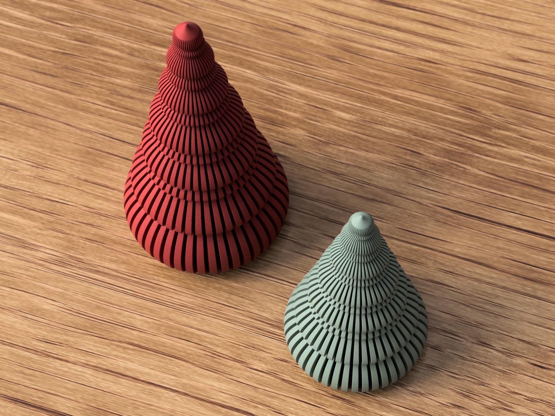 Two textured ceramic objects, one red and one green, on a wooden surface.