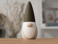 Decorative gnome figure with a brown hat on a wooden surface