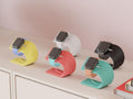 Set of colorful watch stands on a light surface with a neutral background