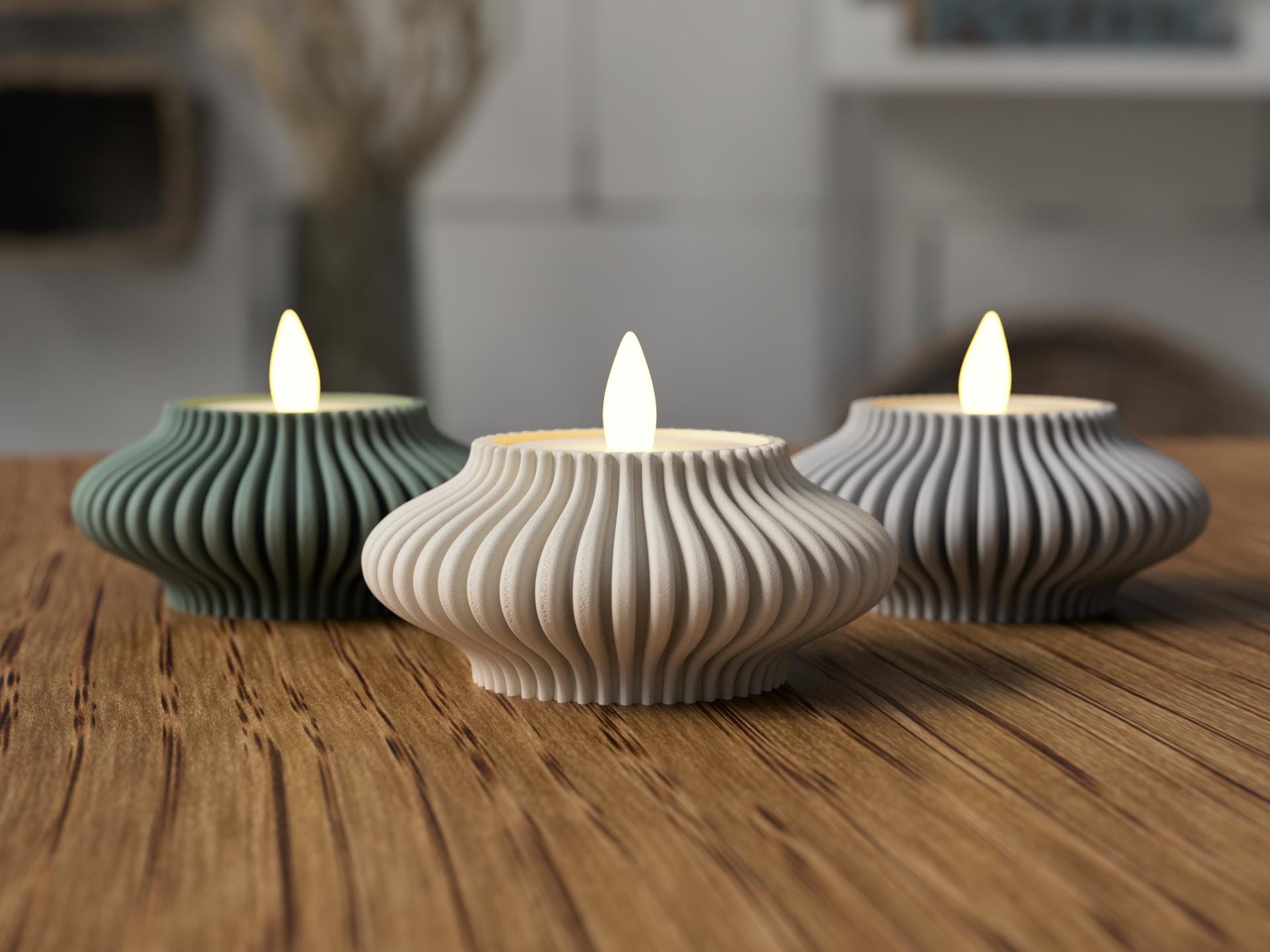 Three ribbed ceramic tealights on a wooden surface with a blurred background