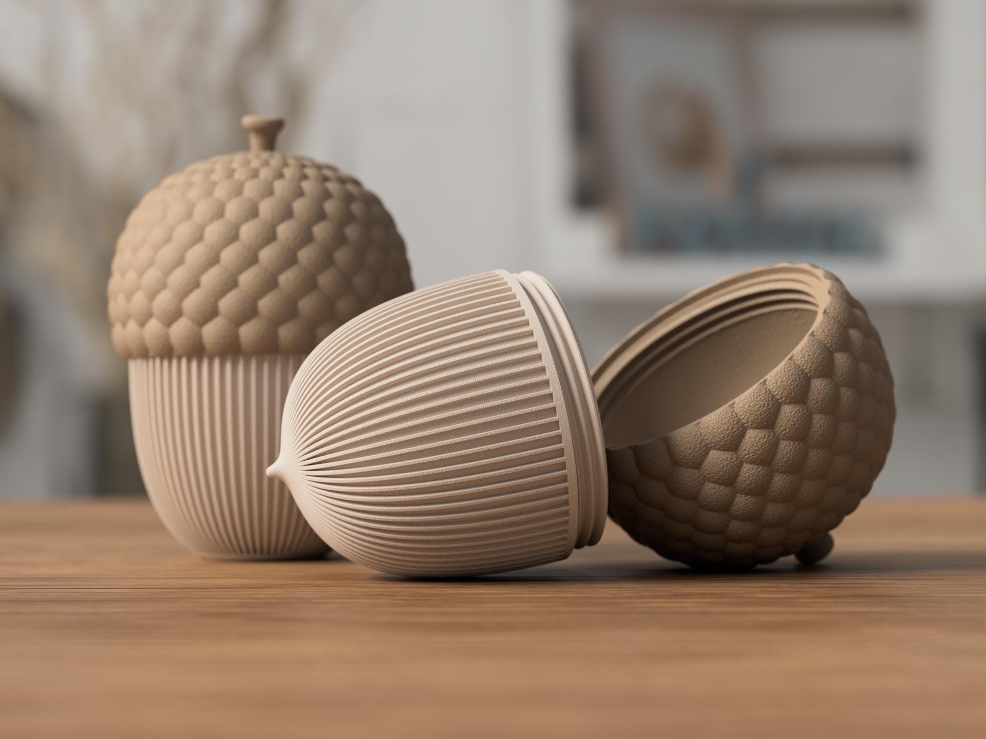 Three ceramic acorn-shaped containers on a wooden surface with a blurred indoor background.