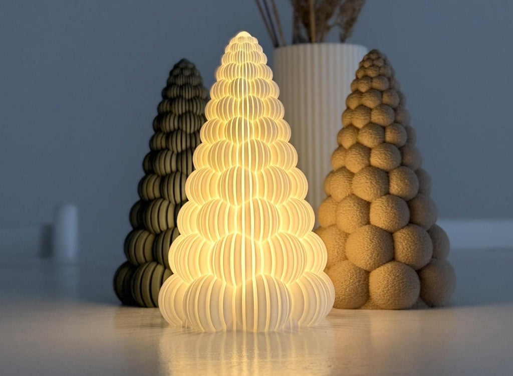 Three cone-shaped lamps on a reflective surface with a neutral background