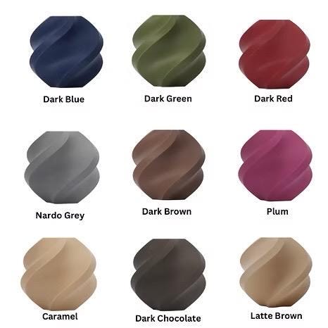 Color swatches of various dark and neutral tones on a white background