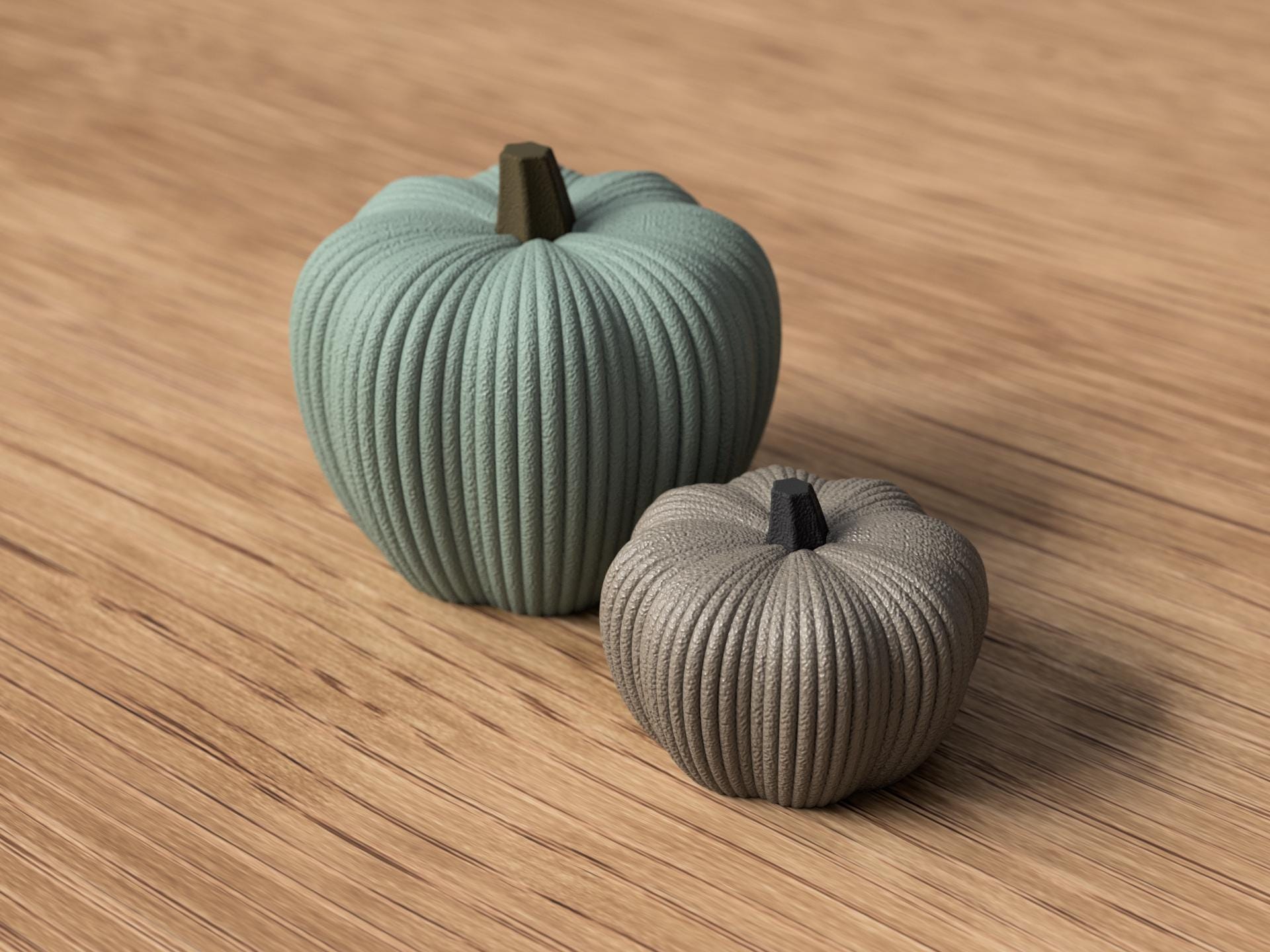 Two ribbed pumpkin decorations on a wooden surface