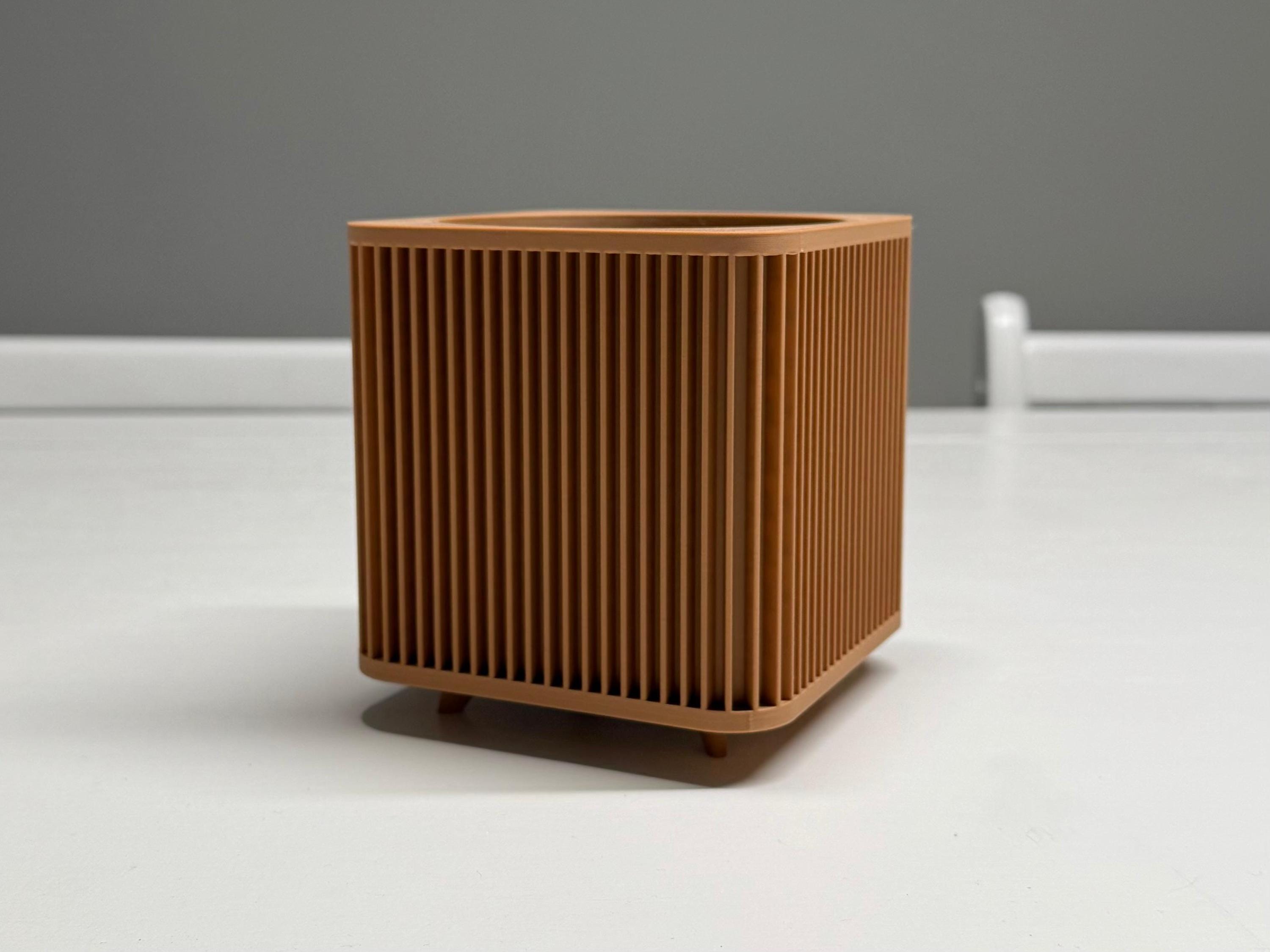 Brown textured cube-shaped object on a white surface with a gray background