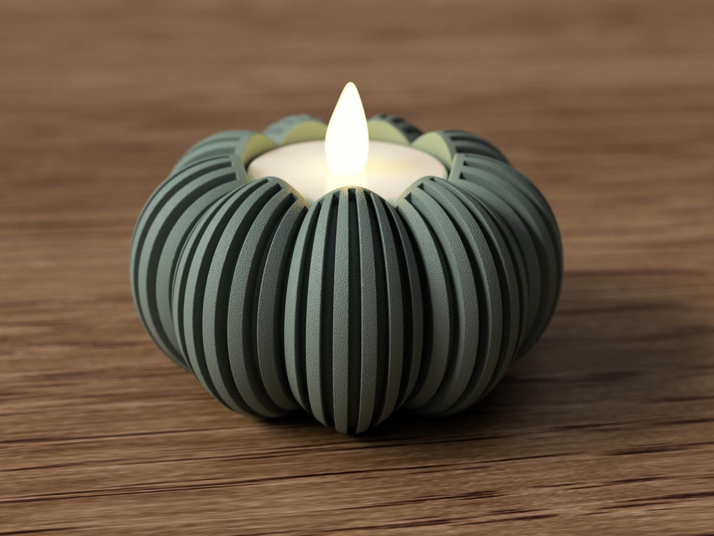 Cylindrical candle holder with a lit candle on a wooden surface