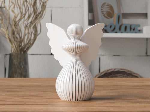 White angel figurine with butterfly wings on a wooden surface