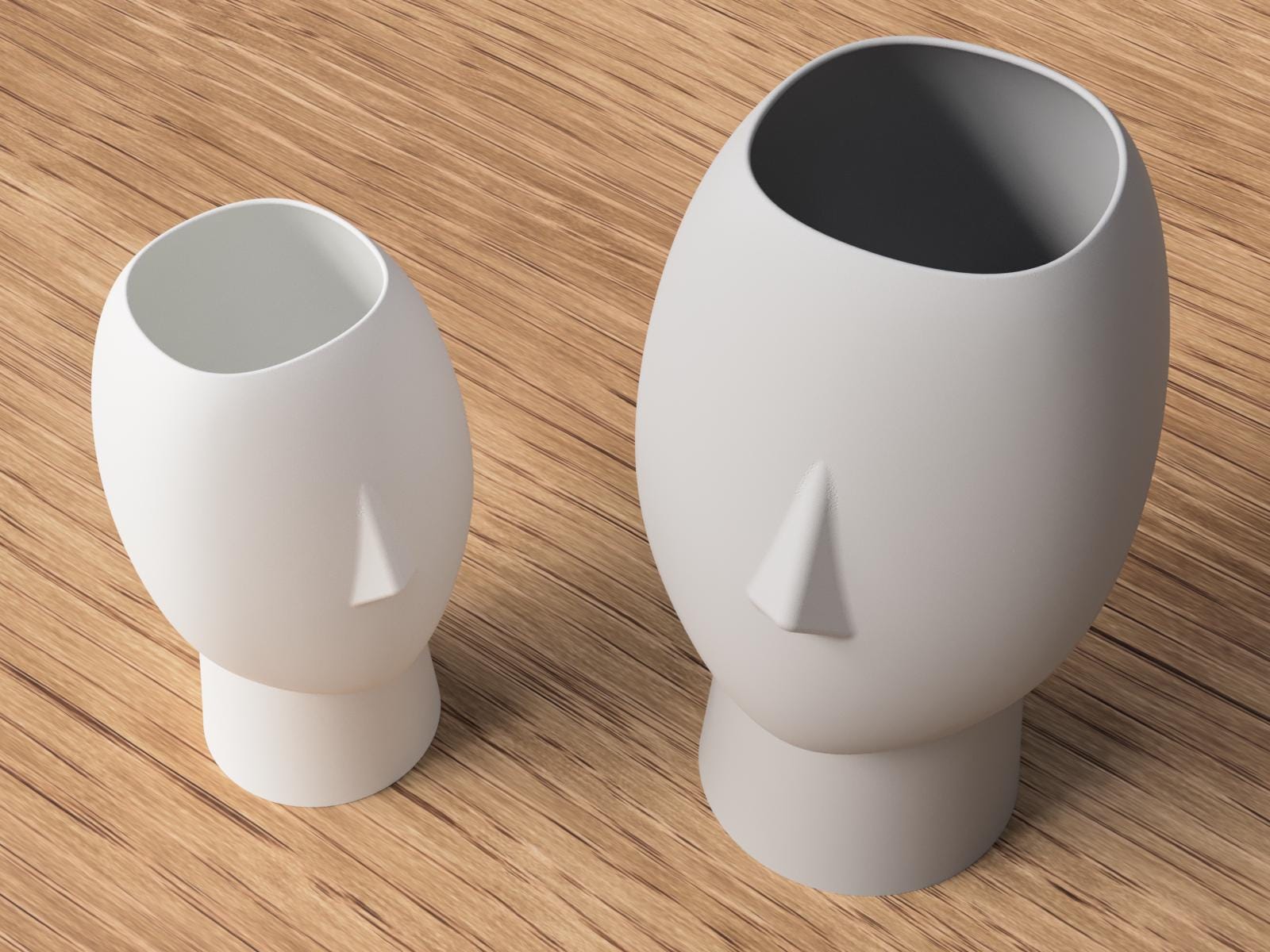 Two white ceramic vases with unique designs on a wooden surface