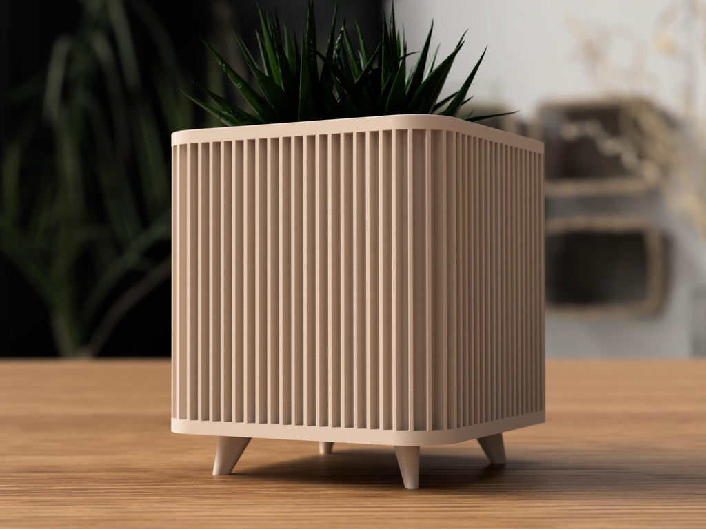 Modern plant pot with geometric design on a wooden surface