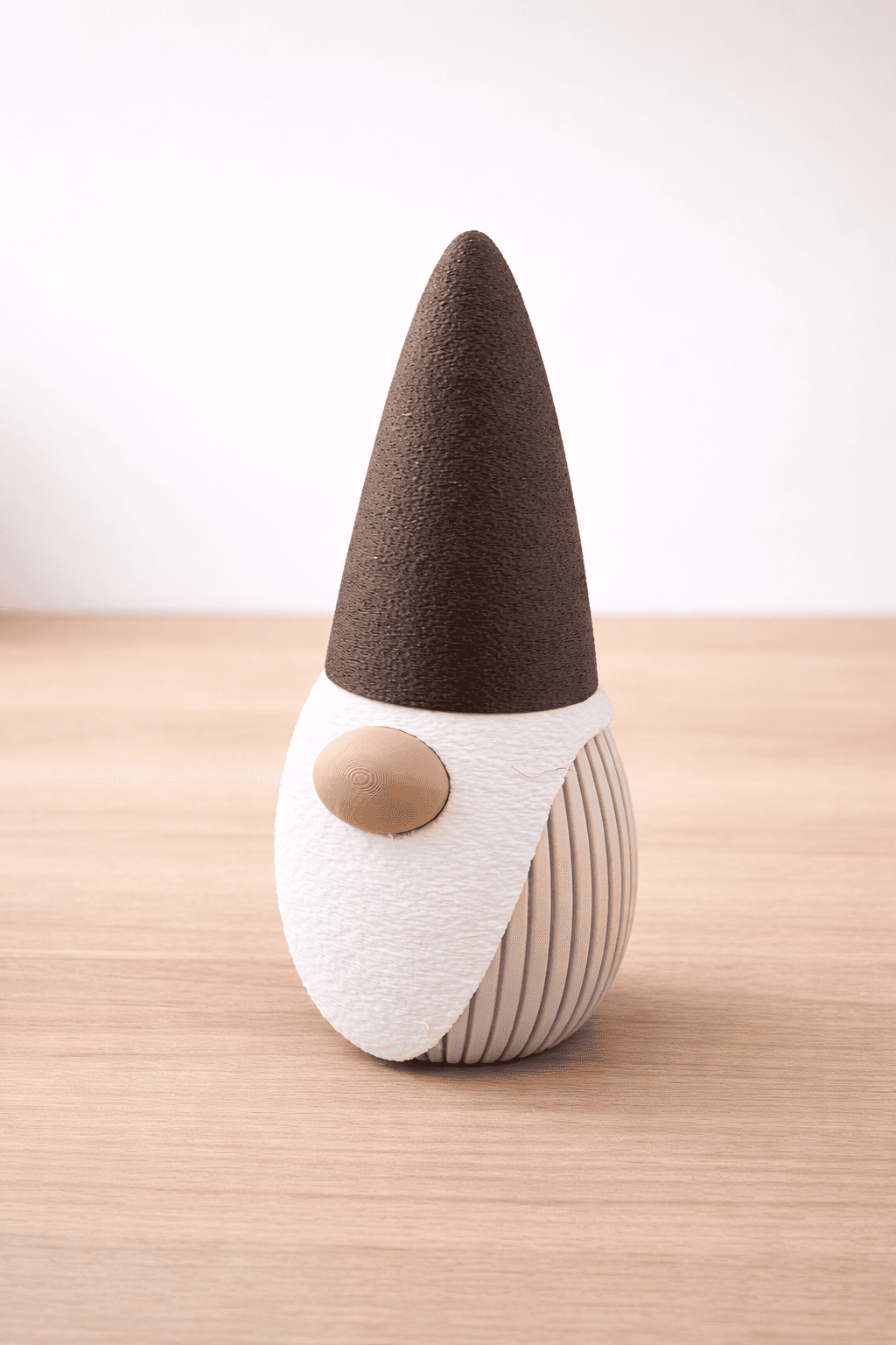 Decorative gnome figurine with a brown hat on a wooden surface