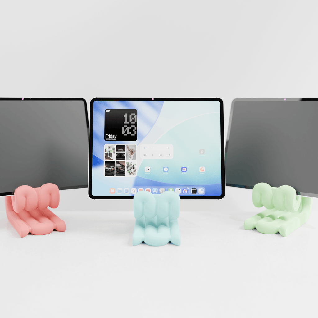 Tablet on a stand with three colorful animal-shaped phone holders in front of it.