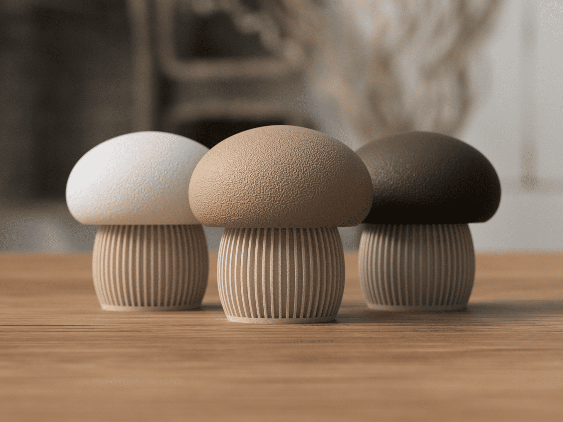 Three mushroom-shaped objects in white, beige, and brown on a wooden surface with a blurred natural background.