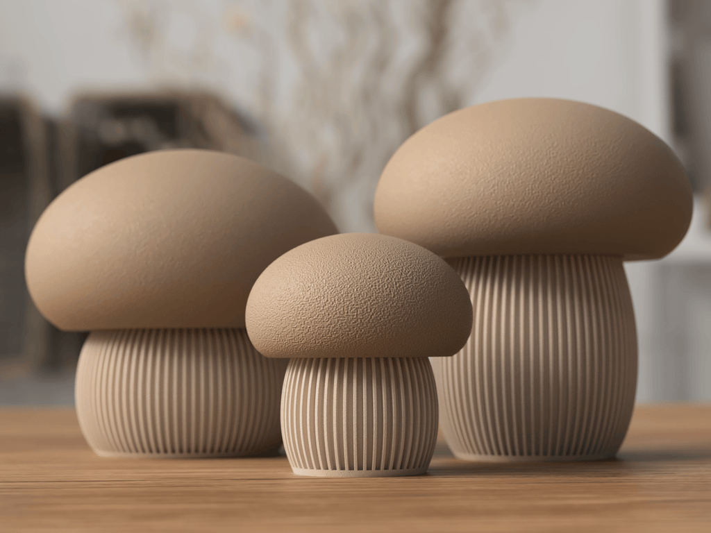 Three beige mushroom-shaped objects on a wooden surface with a blurred background