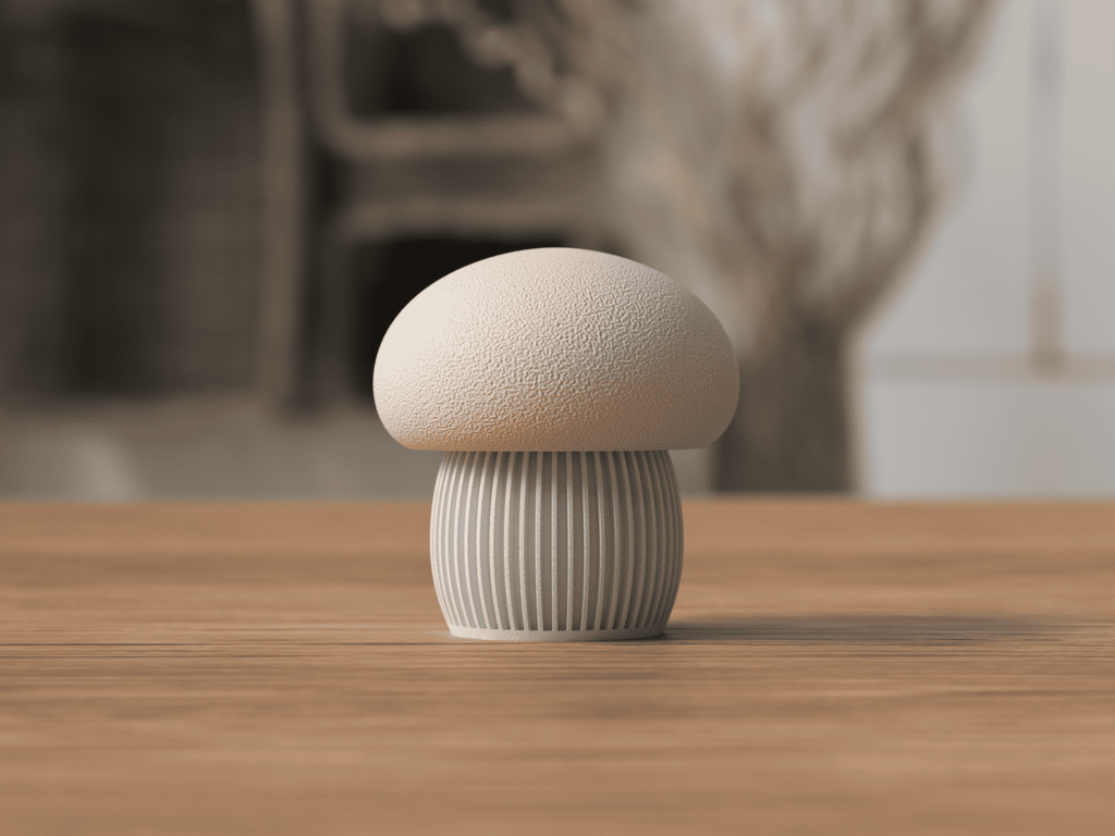 Ceramic mushroom-shaped object on a wooden surface with a blurred natural background