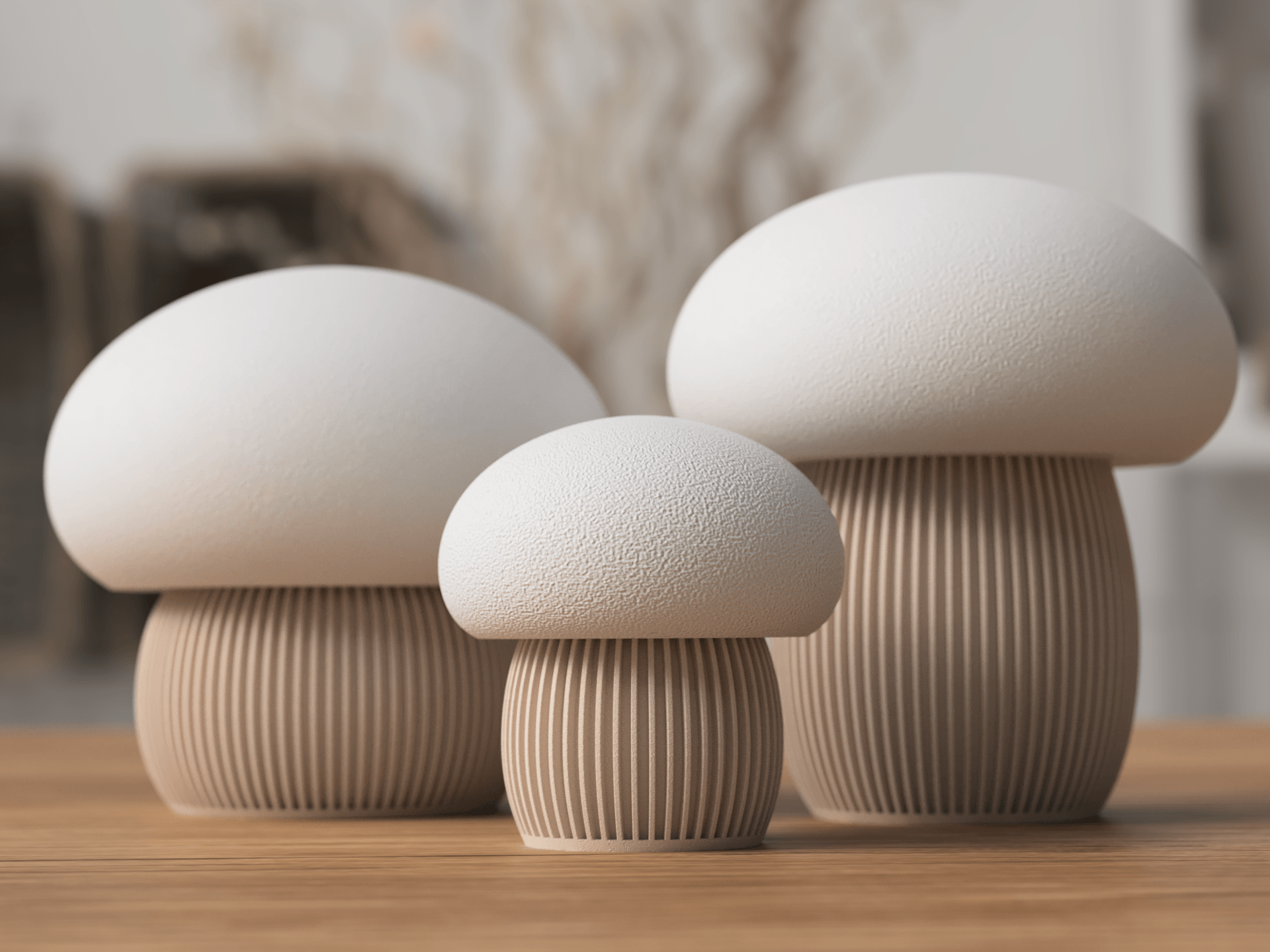 Three ceramic mushroom sculptures on a wooden surface with a blurred background
