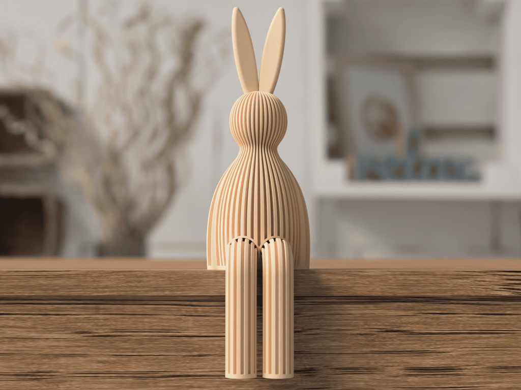 Wooden rabbit sculpture on a wooden surface with a blurred indoor background