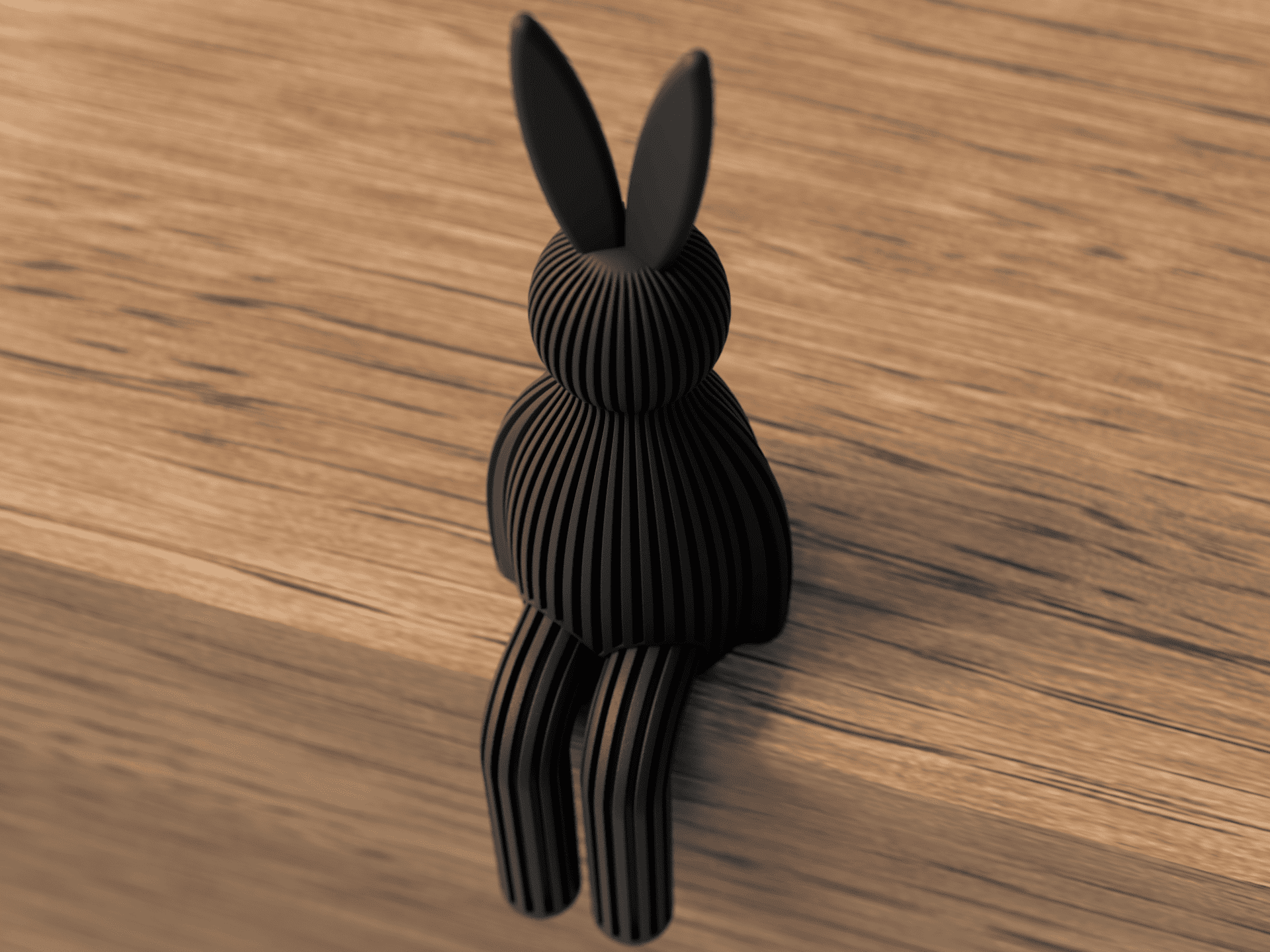 Black rabbit-shaped object on a wooden surface