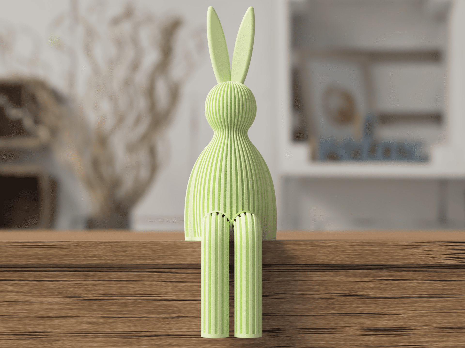 Green rabbit-shaped decorative object on a wooden surface with a blurred indoor background