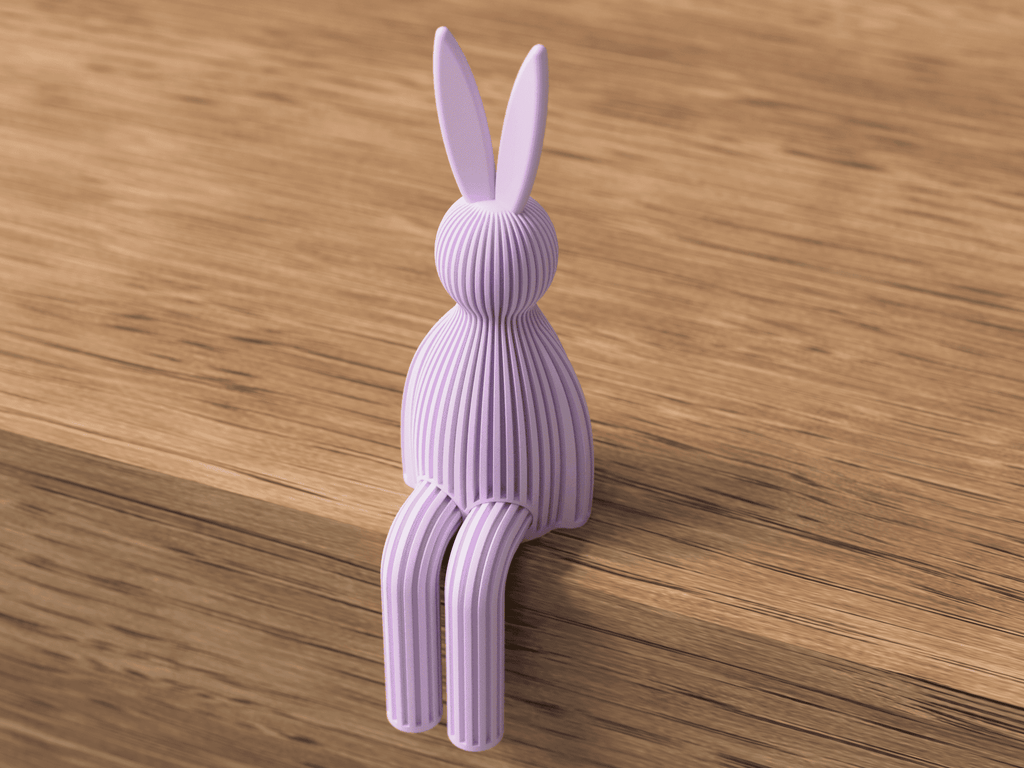 Purple rabbit-shaped object on a wooden surface