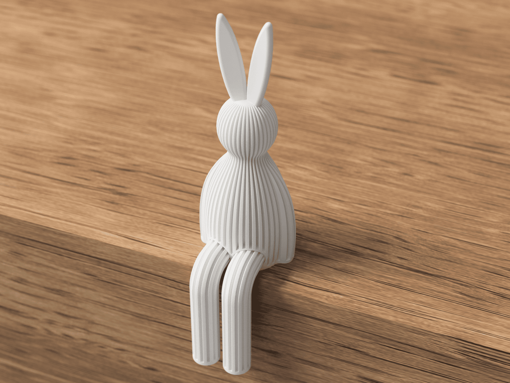 White rabbit-shaped hook on a wooden surface