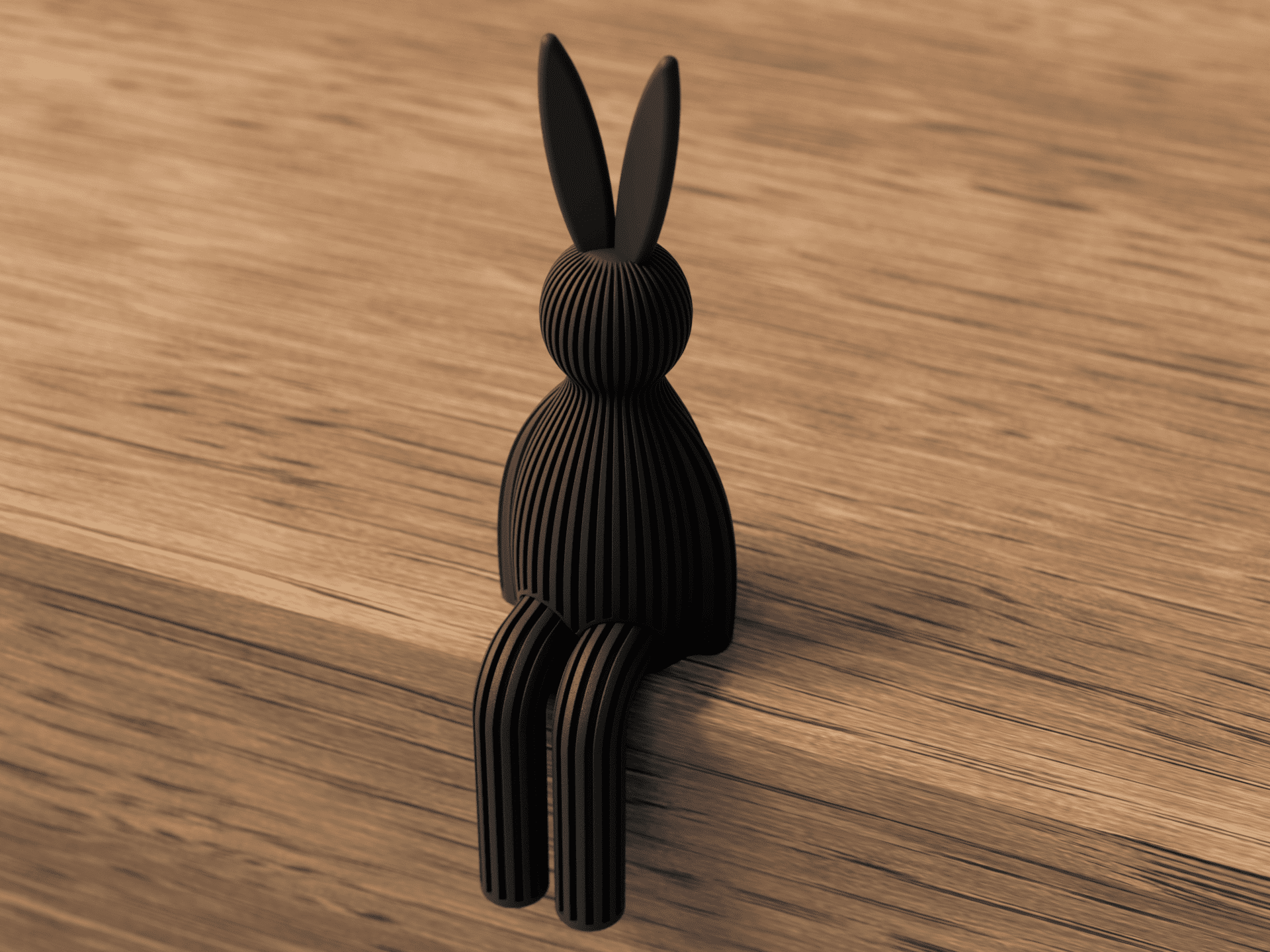 Black rabbit-shaped object on a wooden surface