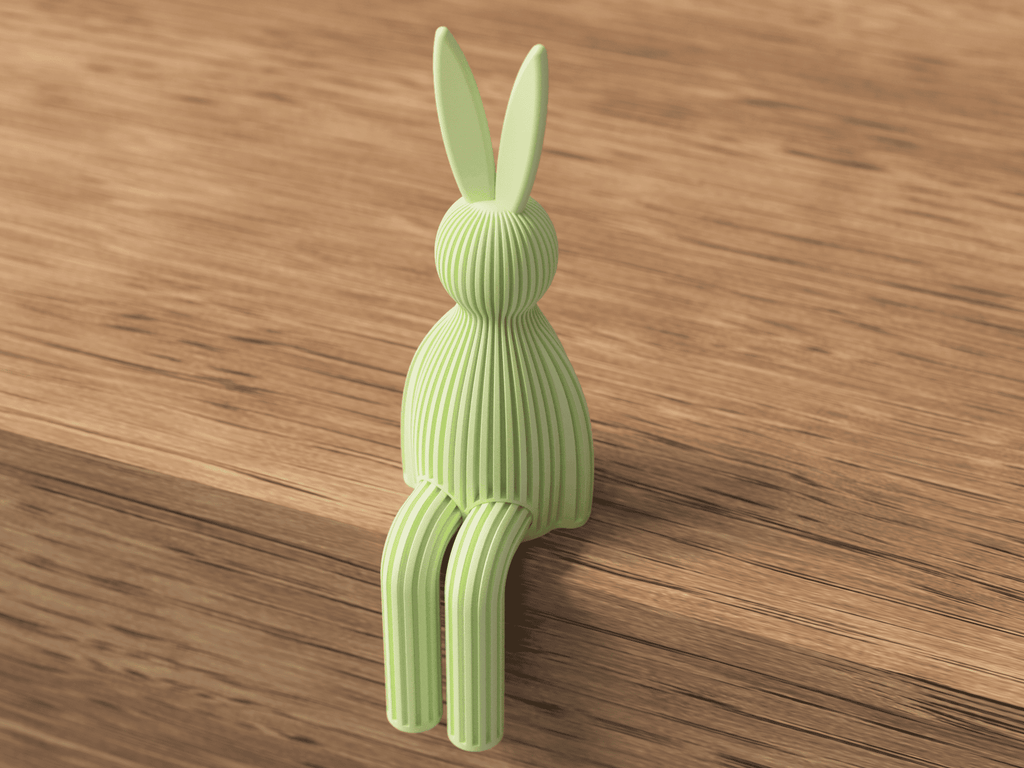 Green rabbit-shaped object on a wooden surface