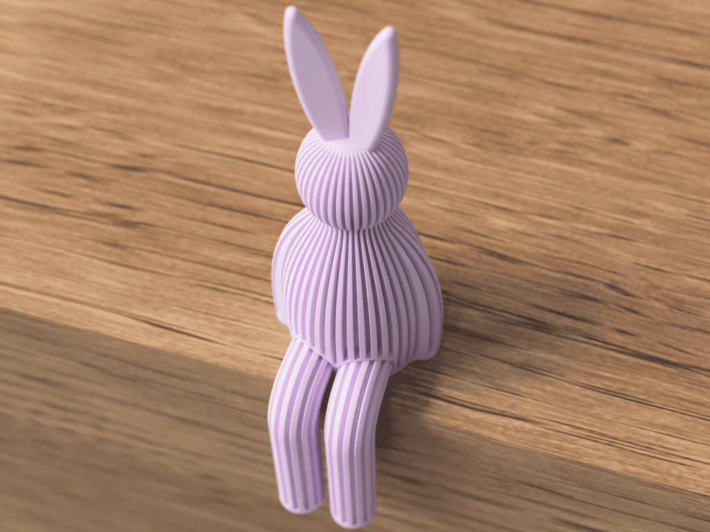 Purple rabbit-shaped object on a wooden surface