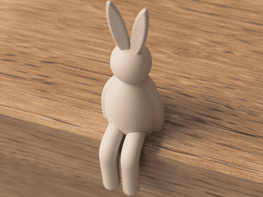 Beige rabbit-shaped hook on a wooden surface