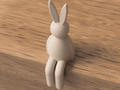 Beige rabbit-shaped hook on a wooden surface