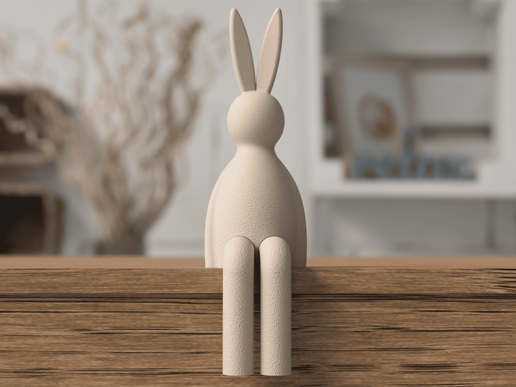 Wooden rabbit sculpture on a wooden surface with a blurred indoor background