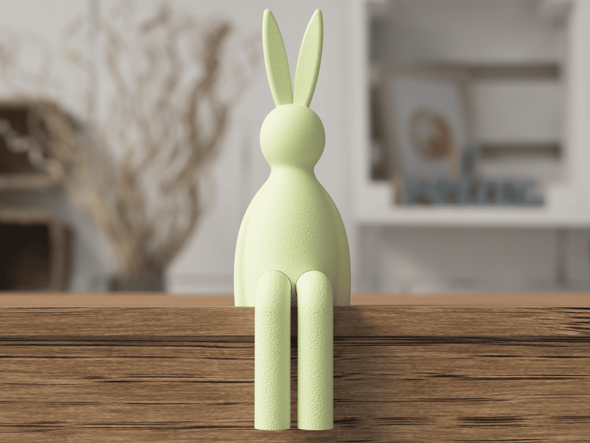 Green rabbit-shaped object on a wooden surface with a blurred indoor background