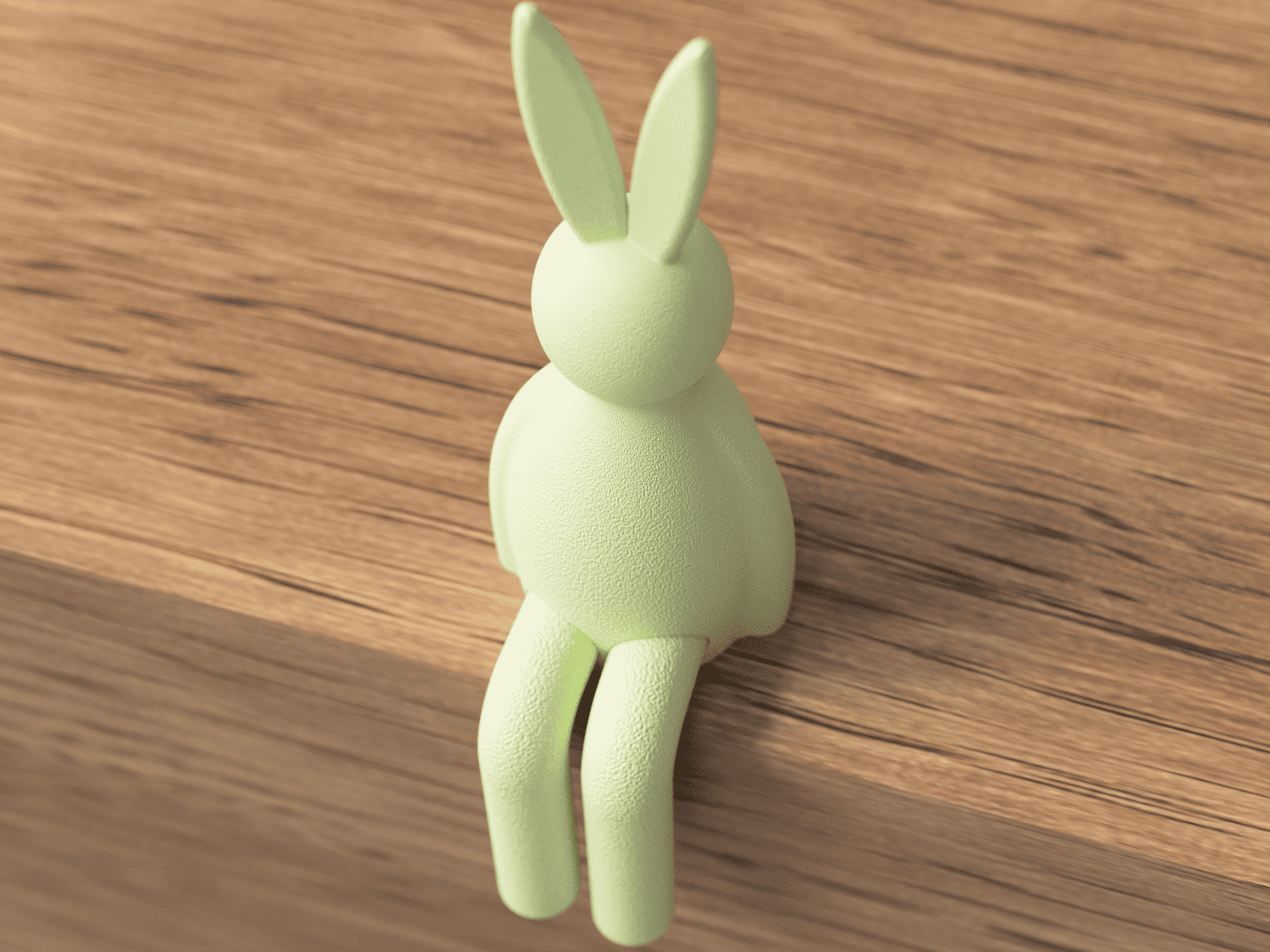 Light green rabbit-shaped object on a wooden surface