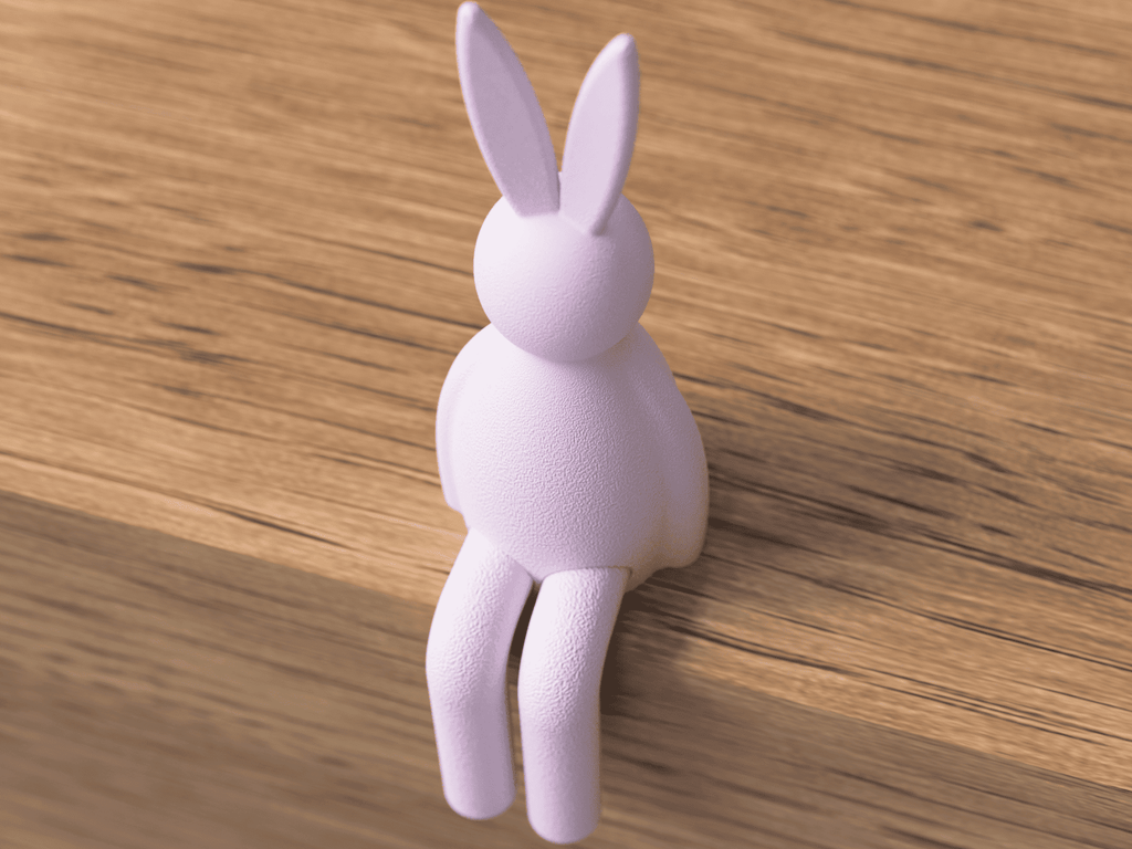 Purple rabbit-shaped object on a wooden surface