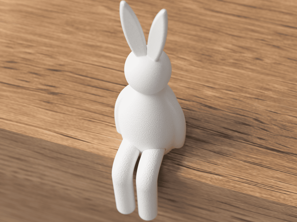 White rabbit-shaped object on a wooden surface