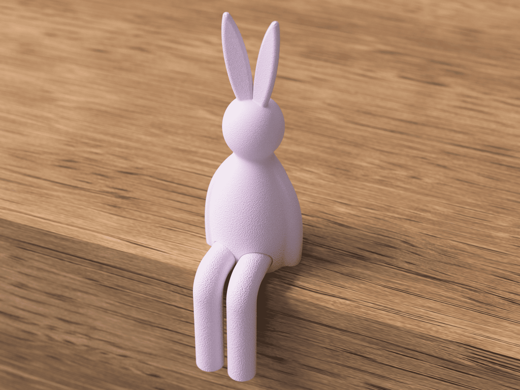White rabbit-shaped hook on a wooden surface