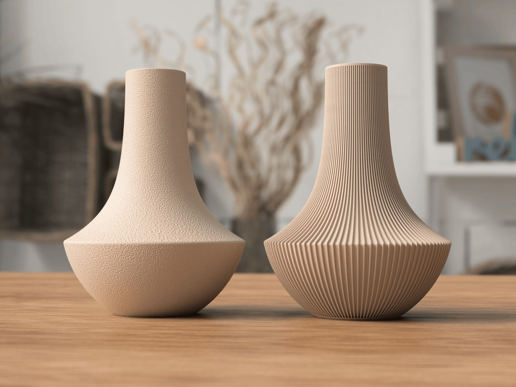 Two beige vases with textured surfaces on a wooden surface.