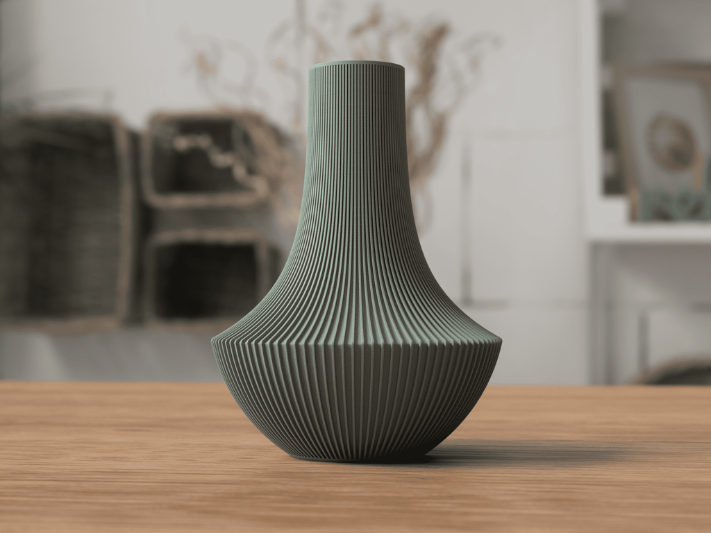 Green textured vase on a wooden surface with a blurred indoor background