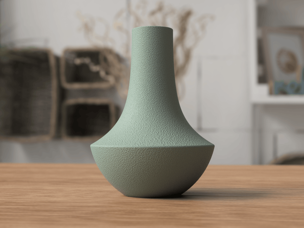 Green textured vase on a wooden table with a blurred indoor background