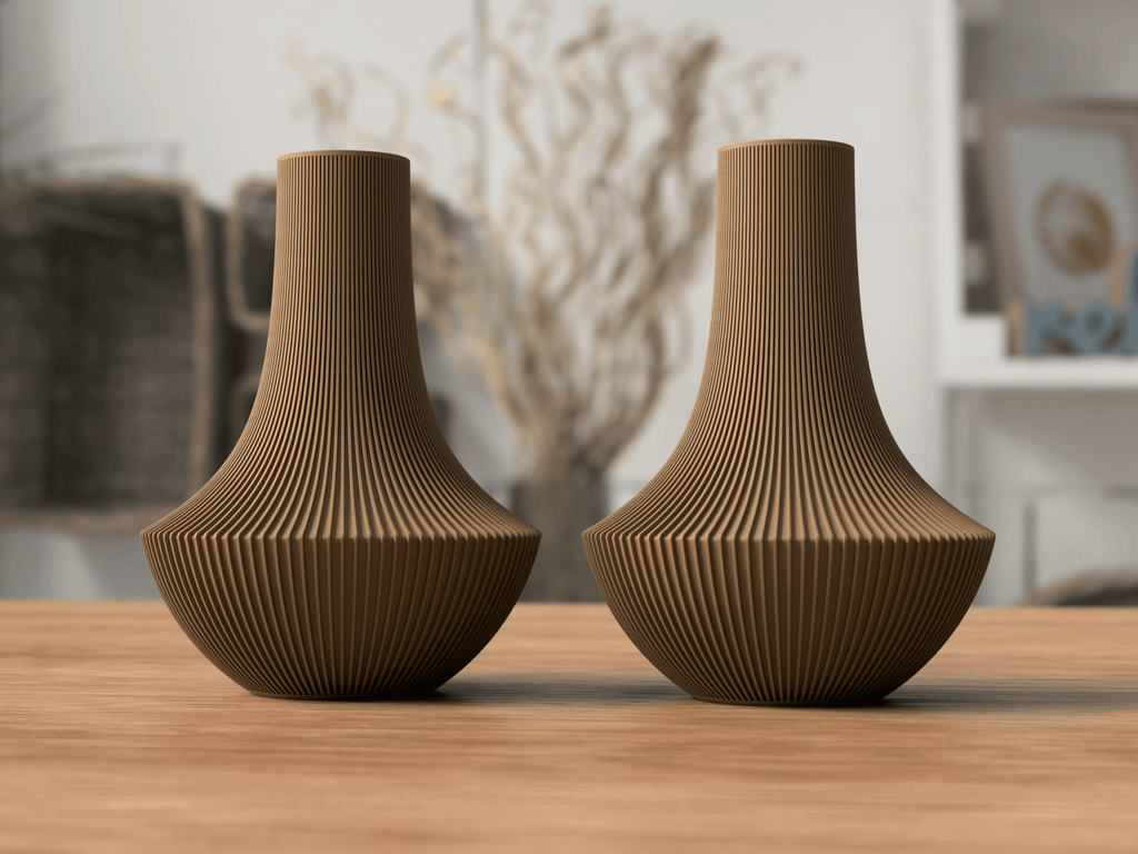 Two brown textured vases on a wooden surface with a blurred indoor background
