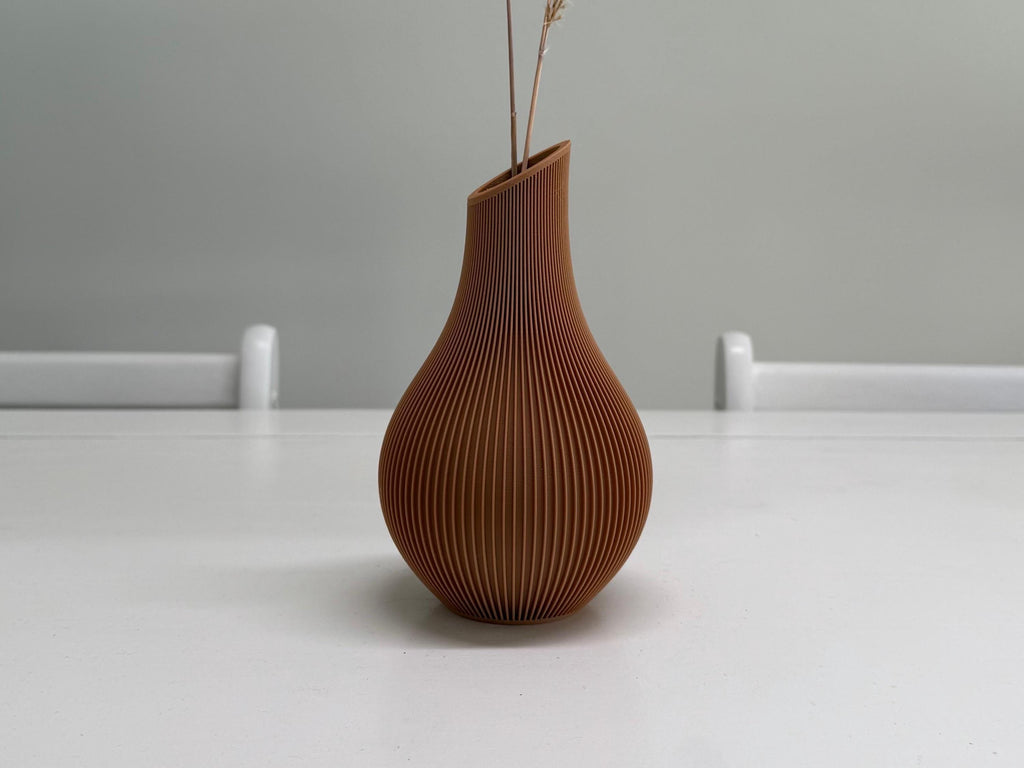 Brown textured vase on a white surface with a gray background
