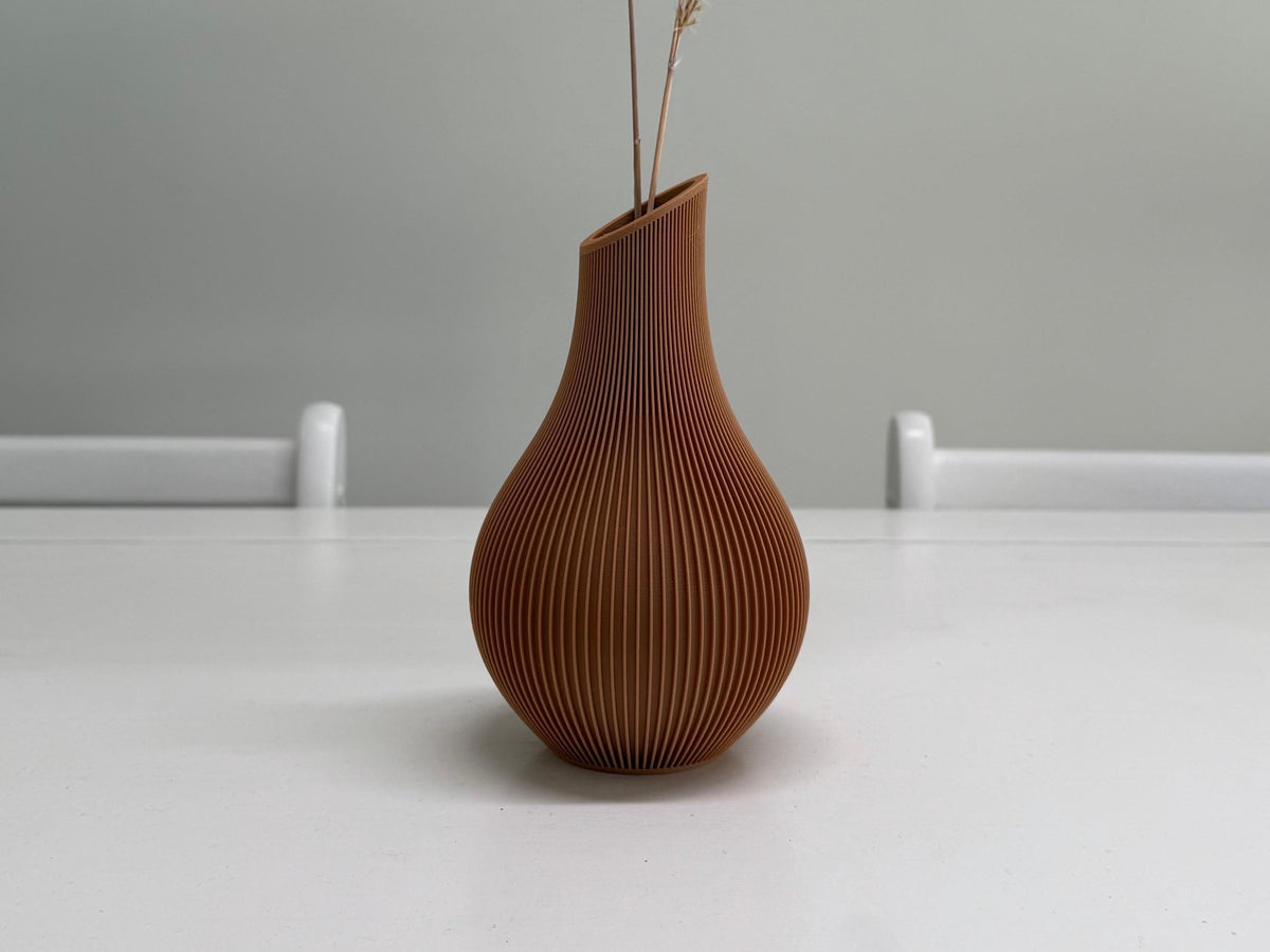 Brown textured vase on a white surface with a gray background